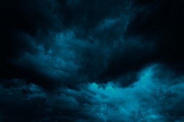 Dramatic blue green sky. Gloomy heavy thunderclouds. Dark teal sky background with copy space for...
