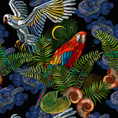 Embroidery. Tropical night. Colorful parrots, palm leaves and moon seamless pattern Fashionable jungle, hot summer background. Template for design of clothes