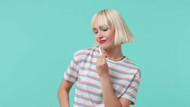 Young blonde short haircut woman 20s wears striped t-shirt dance waving rising expressive gesticulating hands snaps her fingers to music rhythm isolated on pastel plain blue background studio portrait