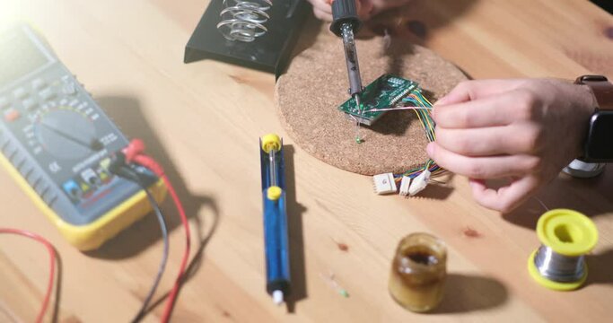 Male Technician Soldering Electronic Circuit Board. Development of Industrial PCB, Silicon Microchips, Semiconductors