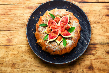 Autumn pie with figs,wooden background