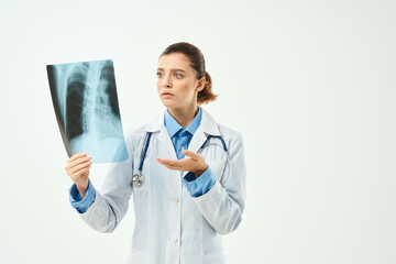 surprised radiologist showing x-ray emotion light background