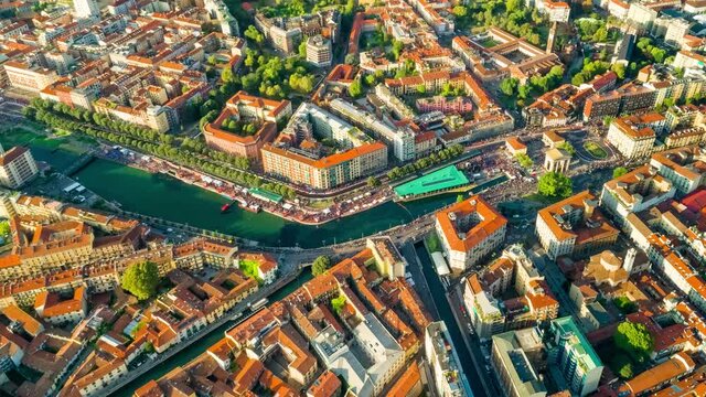 Milan Hyperlapse Time lapse sunset. Aerial Drone Flight Timelapse Of Panoramic Skyline Milano Of Metropolitan City life. People walking on Square Navigli during the fashion week. Drone lapse 4k