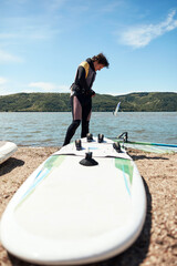Windsurfer surfing on a windy summertime day at the river.