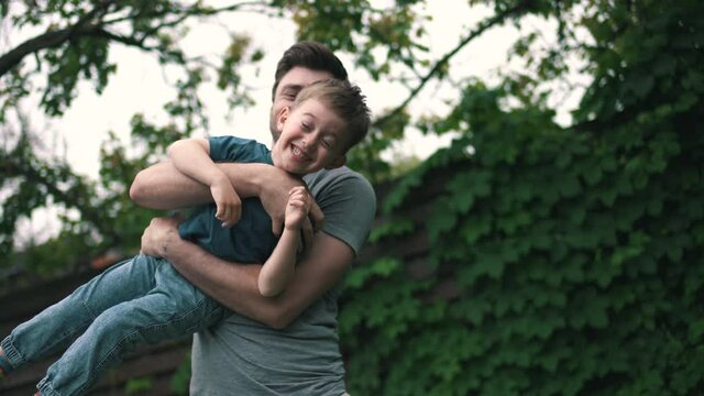 family with a son having fun in the green yard
