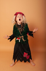 Fototapeta premium a little girl of American appearance laughing out loud in a Costume of Baba Yaga for Halloween