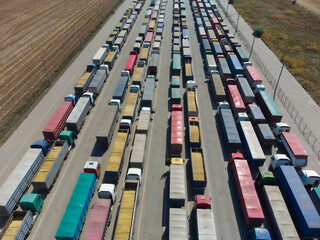 Trucks in line in the parking lot to the terminal in the port.
