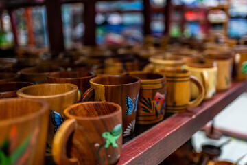 Carved and painted wooden mugs at a market stall
