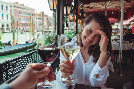 first person point of view couple in cafe outdoors drinking wine smiling woman
