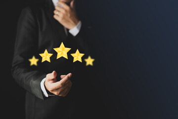 A smart man in a suit who is deciding to give a star rating.-customer experience concept Excellent service, the best for satisfaction.tif