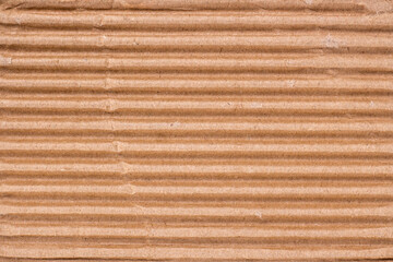 Abstract background from torn cardboard. A piece of thick corrugated paper
