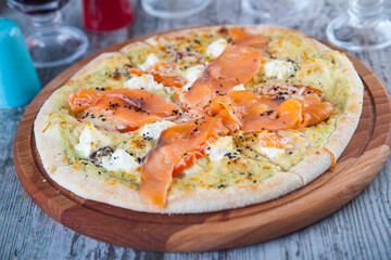 pizza stuffed with tomatoes and cheese on a wooden table