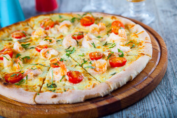 pizza stuffed with tomatoes and cheese on a wooden table