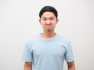 Fototapeta premium Asian man angry emotion at his face blue shirt white isolated