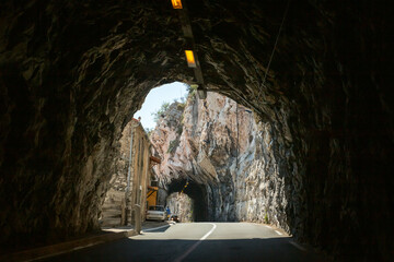 Road tunnel through rock.