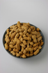Peanuts in Blue Bowl Close Up Vertical View