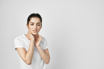 Woman in white t-shirt neck pain treatment health problem