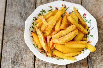  Home made   Fresh fried French fries  in a bowl on wooden rustic  background