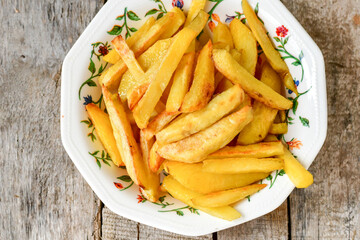  Home made   Fresh fried French fries  in a bowl on wooden rustic  background