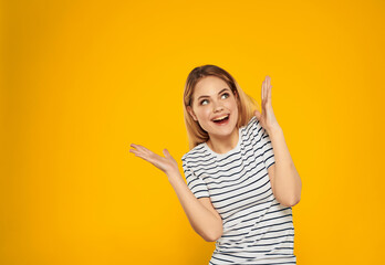 emotional woman in striped t-shirt gesturing with hands posing Studio