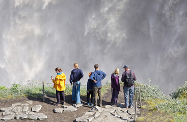 Iceland - August 3, 2021: Tourists at Dettifoss. The waterfall is situated in Vatnajökull National Park in Northeast Iceland, and is reputed to be the most powerful waterfall in Europe