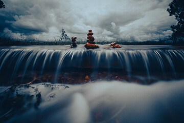 Zen stones over waterfall