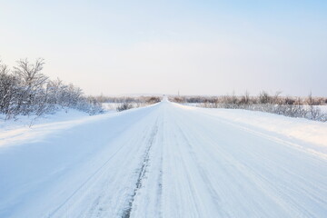 Obraz na płótnie Canvas road at a sunny winter day