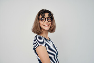 woman in striped t-shirt fashion glasses studio posing