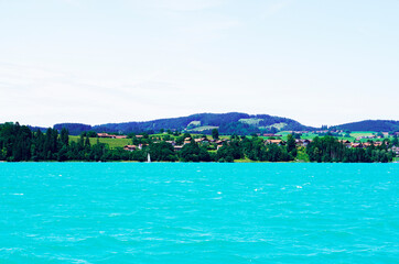 Forggensee near Füssen. Blue lake with surrounding landscape in the Bavarian Allgäu.