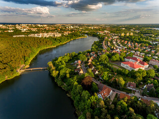 Olsztyn Lake Dlugie, bird's eye view. Wooded shores, the sky reflecting in the water table and a bridge over the lake - Warmia and Masuria, Poland