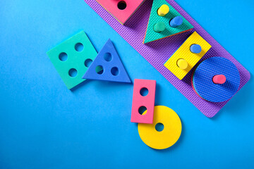 Children's toy on logic in the form of various figures, square, circle, rectangle, triangle on a blue background