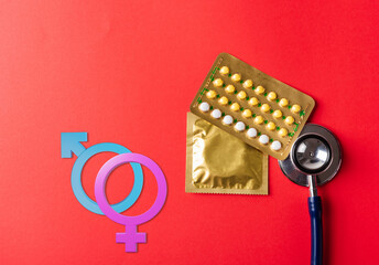 World sexual health or Aids day. Top view flat lay Male, female gender signs, condom in wrapper...