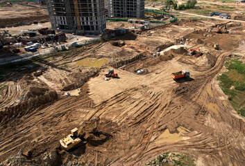 Laying a concrete well ring and sewer pipe at construction site. Earthworks during the install of...