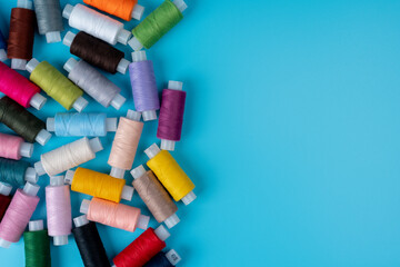Multicolor sewing threads on a blue background