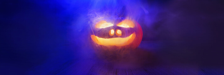 Halloween - pumpkin in cool neon light still life background with copy space