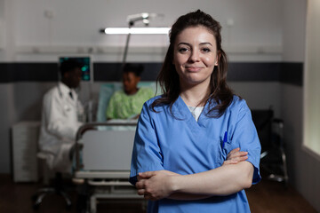Portrait of young adult with nurse occupation in hospital ward. Caucasian woman working as medical...