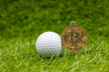 Golf ball with Bitcoin on green grass. 
Bitcoin is a decentralized digital currency, without a central bank or single administrator, that can be sent from user to user on the peer-to-peer bitcoin net