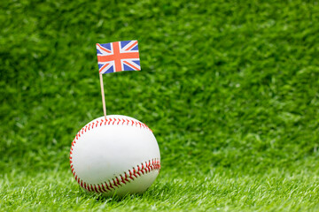 Baseball with Union Jack flag on green grass