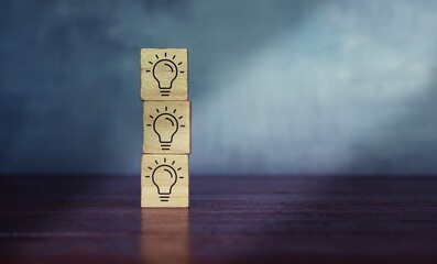 Stack wooden cube with light bulb icon. Concept  of brainstorming, creative idea and innovation