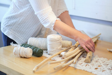 Close-up of hand made macrame texture pattern. ECO friendly modern knitting natural decoration concept. Beautiful boho macrame wall panel will add a cozy atmosphere