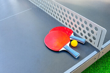 Table tennis rackets close-up. Playing table tennis outdoors at the open air sport ground.