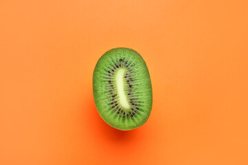 Piece of fresh kiwi fruit on color background