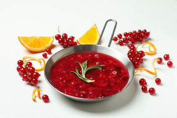Cranberry sauce and ingredients on white background