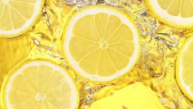 Super Slow Motion Shot of Splashing Fresh Lemon Slices into Water at 1000 fps.