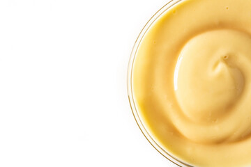 Pastry cream in a bowl isolated on white background. Top view. Copy space	