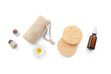 Composition with cosmetic product, makeup sponges and loofah on white background