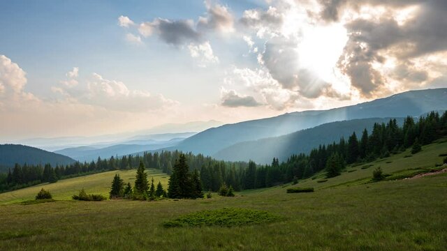 Time lapse at sunset with beautiful moving clouds over the tree-covered mountain slopes, the Rhodopes in Bulgaria