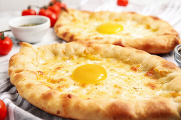 Fresh delicious Adjarian khachapuris on table, closeup