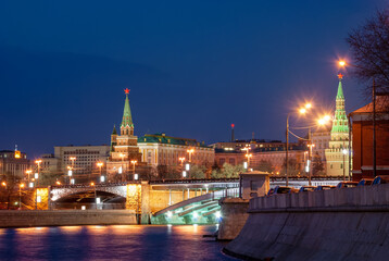 Embankment of Moscow rivers on the background of the Moscow Kremlin. Evening city landscape.