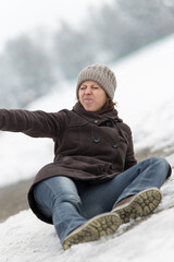 young woman lying on a icy street and appeal for help